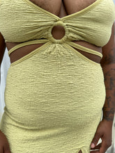 Load image into Gallery viewer, Close up view of the cut-outs and strappy details of a size XL Urban Outfitters chartreuse textured cut-out maxi dress with a side slit styled on a size 14/16 model. The photo is taken outside in natural lighting.

