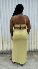 Load image into Gallery viewer, Full-body back view of a size XL Urban Outfitters chartreuse textured cut-out maxi dress with a side slit styled with black sides on a size 14/16 model. The photo is taken outside in natural lighting.
