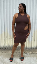 Load image into Gallery viewer, Full-body front view of a size 14 Pretty Little Thing dark brown ribbed cut-out mini bodycon dress styled with black slides on a size 14/16 model. The photo is taken outside in natural lighting.
