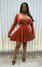 Load image into Gallery viewer, Additional full-body front view of a size XL Kim Chi Blue peachy-orange velvet long sleeve a-line mini dress styled with black heels on a size 14/16 model. The photo is taken outside in natural lighting.
