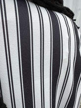 Load image into Gallery viewer, Close up view of the pattern of a size 18 Pink Clove black and white vertical striped collared duster on a size 14/16 model. The photo is taken outside in natural lighting.
