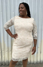 Load image into Gallery viewer, Front view of a size 16 Eliza J off-white embroidered and sequined boatneck midi dress with three-quarter length sleeves on a size 14/16 model. The photo is taken outside in natural lighting.
