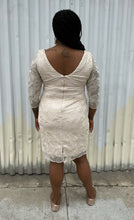 Load image into Gallery viewer, Full-body back view of a size 16 Eliza J off-white embroidered and sequined boatneck midi dress with three-quarter length sleeves styled with gold flats on a size 14/16 model. The photo is taken outside in natural lighting.
