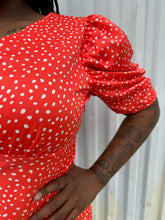 Load image into Gallery viewer, Close view of the puffed shoulder and darting at the bust of a size 14 ASOS bright red and white polka dot v-neck puff sleeve blouse styled with medium wash denim on a size 14/16 model. The photo is taken outside in natural lighting.
