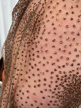 Load image into Gallery viewer, Close up view of the metallic gold swiss dot details of a size 22/24 Eloquii dark brown sheer puff sleeve pussybow blouse styled tucked into a pair of rust colored silky pants on a size 22/24 model. The photo is taken outside in natural lighting.
