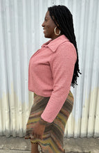Load image into Gallery viewer, Side view of a LIVD Apparel size 1X dusty rose fuzzy collared crop jacket styled open over a white ribbed tank and earth tone striped skirt on a size 14/16 model. The photo is taken outside in natural lighting.
