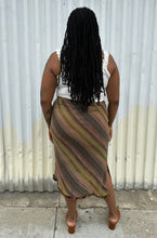 Load image into Gallery viewer, Full-body back view of a size 14 Nancy Bolen City Girl vintage earth tone horizonatl striped midi skirt styled with a ribbed whit tank and warm tone brown mules on a size 14 model. The photo is taken outside in natural lighting.
