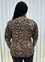 Load image into Gallery viewer, Back view of a size XXL Halogen leopard pattern three-quarter length sleeve turtleneck sweater styled with black pants on a size 14/16 model. The photo is taken outside in natural lighting. 
