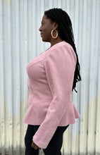 Load image into Gallery viewer, Side view of a size 16 Lane Bryant baby pink suede zip-up corset-back jacket styled over black pants on a size 14/16 model. The photo is taken outside in natural lighting.
