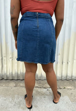 Load image into Gallery viewer, Back view of a size 16 ASOS medium wash denim pencil skirt styled with a rust-peach cropped tank and black flats on a size 14/16 model. The photo is taken outside in natural lighting.
