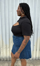 Load image into Gallery viewer, Side view of a size 16 Pretty Little Thing black collared bodysuit with bust cut-out styled tucked into a medium wash denim skirt on a size 14/16 model. The photo is taken outside in natural lighting.
