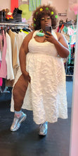 Load image into Gallery viewer, Final full-body front view of a FTF Lab x La&#39;Tecia Thomas cream-colored textured halter maxi dress with a high-high side slit styled with silver sneakers and bold earrings on a size 22/24 model.
