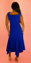 Load image into Gallery viewer, Full-body back view of a size 16 Reem Acra for 11 Honoré cobalt blue subtle cowl neck sleeveless maxi with handkerchief hem styled with tan patent leather heels on a size 10/12 model.
