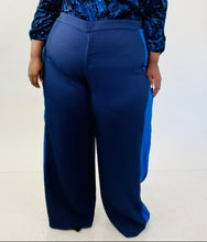 Load image into Gallery viewer, Close up shot of these size 28 Eloquii navy blue wide leg trousers with light blue racing stripes down the sides on a size 24/26 model.
