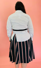 Load image into Gallery viewer, Back view of a size L TOME for 11 Honoré white, green, blue, red, and black mixed pinstripe and triple stripe collared button-up shirt dress with tie belt on a size 14/16 model.
