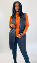Load image into Gallery viewer, Front view of this size L Gershon Bram black faux suede duster vest styled over an orange turtlneck blouse and gray leopard print pants on a size 12 model.
