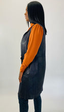 Load image into Gallery viewer, Side view of this size L Gershon Bram black faux suede duster vest styled over an orange turtlneck blouse and gray leopard print pants on a size 12 model.

