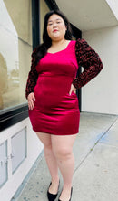Load image into Gallery viewer, Additional full-body front view of a red velvet bodycon mini dress with black velvet puff sleeves with red sequins styled with black heels on a size 14/16 model.
