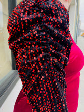 Load image into Gallery viewer, Close up view of the black velvet puff sleeves and red sequin details of a red velvet bodycon mini dress with black velvet puff sleeves with red sequins on a size 14/16 model.
