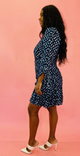 Load image into Gallery viewer, Full-body side view of a size 14 Tanya Taylor for 11HONORÉ navy blue long sleeve mini dress with light blue, and metallic silver swiss dot sheer overlay, ruffles and gathering, and a high neck styled with white heels on a size 10/12 model.

