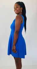 Load image into Gallery viewer, Side view of a size 14/16 Milly for 11Honoré cobalt blue a-line sleeveless mini dress with twisted neckline on a size 12 model.

