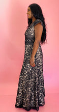 Load image into Gallery viewer, Full-body side view of a size 12 Monique Lhuillier for 11 Honoré cream with black floral lace v-neck gown with stripe details and cap sleeves on a size 10/12 model.
