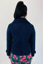 Load image into Gallery viewer, Back view of a size L BB Dakota navy blue blazer-style cropped peacoat styled with a periwinkle sweater and green floral pants on a size 12 model.
