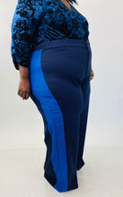 Load image into Gallery viewer, Close up side-view shot of these size 28 Eloquii navy blue wide leg trousers with light blue racing stripes down the sides on a size 24/26 model.
