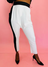 Load image into Gallery viewer, Front view of a pair of size 3 Baja East for 11 Honoré crisp white drop-crotch tapered pants with a black side stripe and elastic waistband styled with black pumps on a size 12 model.
