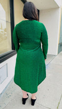 Load image into Gallery viewer, Full-body back view of a size 16 Bloomchic emerald green shimmer blackground dress with long sleeves and tulip hem on a size 14/16 model.
