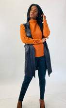 Load image into Gallery viewer, Additional full-body front view of this size L Gershon Bram black faux suede duster vest styled over an orange turtlneck blouse, gray leopard print pants, and black pumps on a size 12 model.
