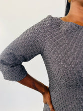 Load image into Gallery viewer, Close up of the three-quarter length sleeve on this size 16 Michael Kors dark gray and silver metallic textured dress on a size 12 model.
