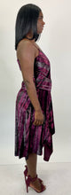 Load image into Gallery viewer, Full-body side view of a size 12 Parker NY for 11 Honoré maroon-purple velvet shift midi dress with asymmertical handkerchief hemline styled with maroon heels on a size 12 model. The photo is taken inside in studio lighting.

