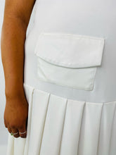 Load image into Gallery viewer, Close up on the pocket detail at the waist of this size 16 Jamie Wei Huang white asymmetrical hem midi dress with pleated skirt, pocket details, and faux leather straps on a size 18/20 model.
