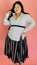 Load image into Gallery viewer, Front view of a size L TOME for 11 Honoré white, green, blue, red, and black mixed pinstripe and triple stripe collared button-up shirt dress with tie belt on a size 14/16 model.
