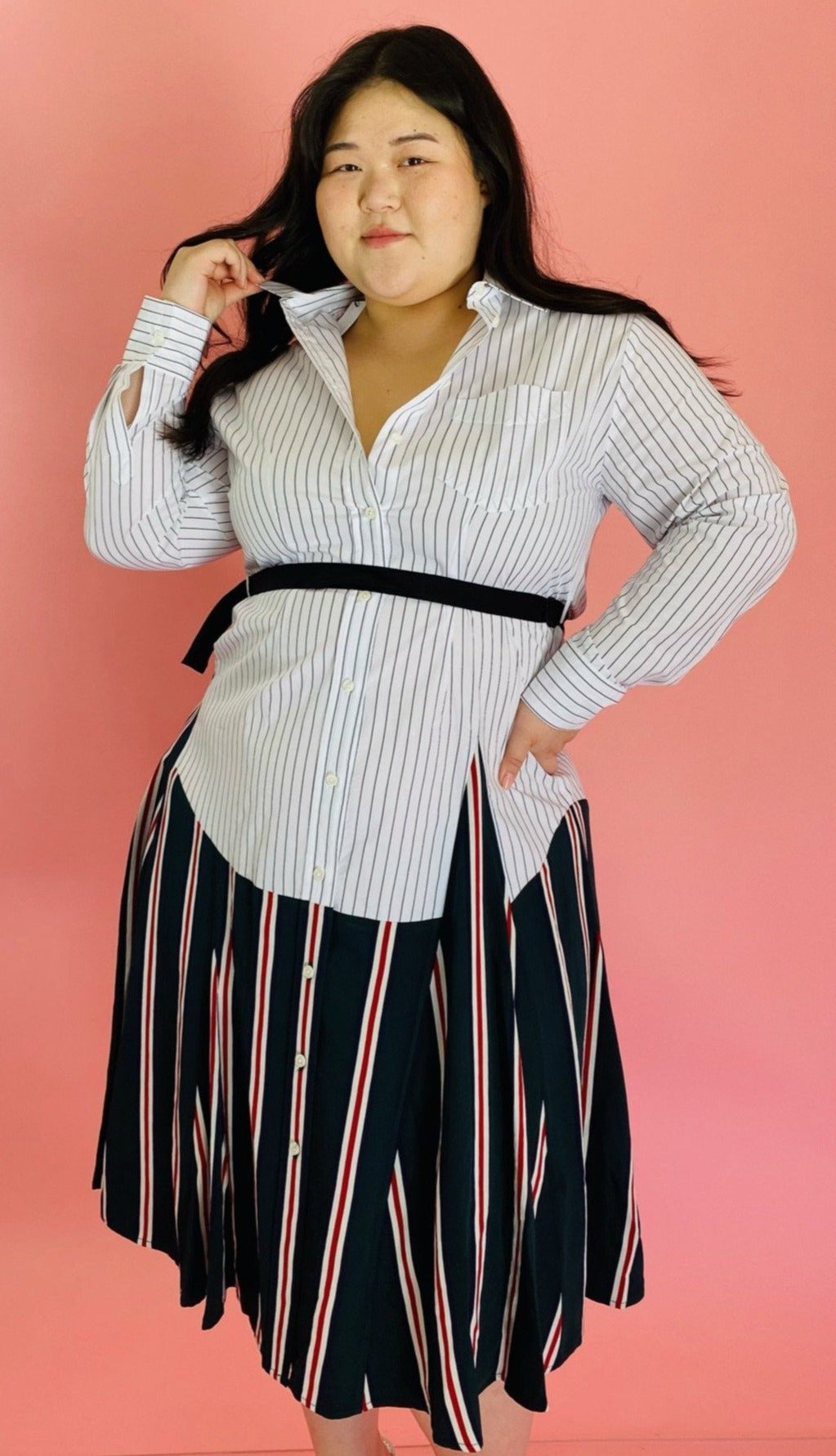 Front view of a size L TOME for 11 Honoré white, green, blue, red, and black mixed pinstripe and triple stripe collared button-up shirt dress with tie belt on a size 14/16 model.