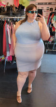 Load image into Gallery viewer, Full-body front view of a size 4XL WRAY bably blue mesh mockneck tank styled tucked into a pale blue mini skirt with blue rectangular sunnies on a size 24 model.
