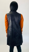 Load image into Gallery viewer, Back view of this size L Gershon Bram black faux suede duster vest styled over an orange turtlneck blouse and gray leopard print pants on a size 12 model.
