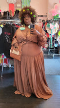 Load image into Gallery viewer, Additional full-body front view of a size 4 Fashion to Figure brown tiered maxi wrap dress with a tortoiseshell belt buckle styled with neon accessories on a size 22/24 model.  The color of the dress in this photo is pulling more neutral than it really is. 
