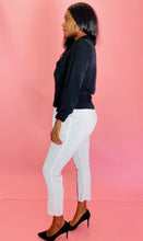 Load image into Gallery viewer, Full-body side view of a pair of size 3 Baja East for 11 Honoré crisp white drop-crotch tapered pants with a black side stripe and elastic waistband styled with a black blouse and black pumps on a size 12 model.
