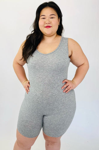 A size 16 Pretty Little Thing light heather gray sleeveless unitard on a size 14/16 model.