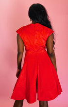 Load image into Gallery viewer, Back view of a size 14 Zac Posen for 11 Honoré vibrant red floral burnout pattern a-line midi dress with cap sleeves and burnout stripe hem on a size 10/12 model.
