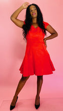 Load image into Gallery viewer, Full-body front view of a size 14 Zac Posen for 11 Honoré vibrant red floral burnout pattern a-line midi dress with cap sleeves and burnout stripe hem styled with black pumps on a size 10/12 model.
