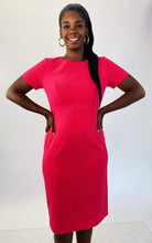 Load image into Gallery viewer, A size 14 Black Halo for 11Honoré hot pink cap sleeve short sleeve midi sheath dress on a size 12 model.

