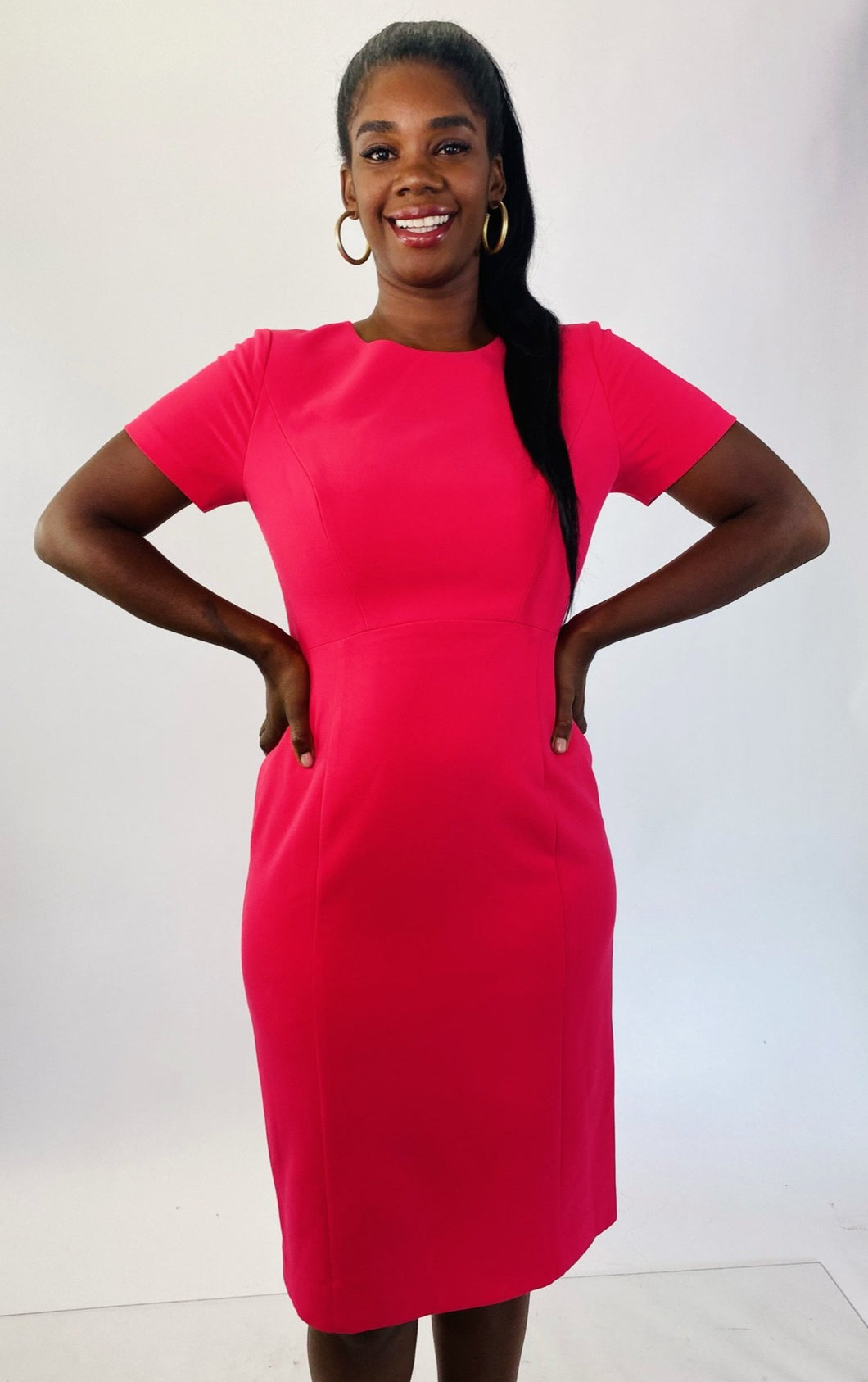A size 14 Black Halo for 11Honoré hot pink cap sleeve short sleeve midi sheath dress on a size 12 model.