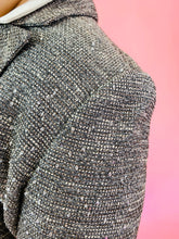 Load image into Gallery viewer, Close up detail shot of the textured tweed of this size 18 Lela Rose gray tweed, textured blazer and skirt 2-piece suit set with black unfinished fringe hem.
