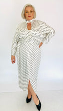 Load image into Gallery viewer, Full-body front view of a Monique Lhuillier for 11Honoré silky white gown with black mini butterfly print, choker and kethole details, and puff sleeves styled with black pumps on a size 18/20 model.
