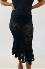 Load image into Gallery viewer, Closer detail of the black mermaid-style lace overlay skirt pf this Fashion to Figure size 1 off-the-shoulder black bodysuit maxi dress with black lace overlay and mermaid-style skirt on a size 12 model.
