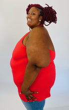 Load image into Gallery viewer, Side view of a size 6 Torrid coral red v-neck halter tank styled with light wash jeans on a size 26/28 model.
