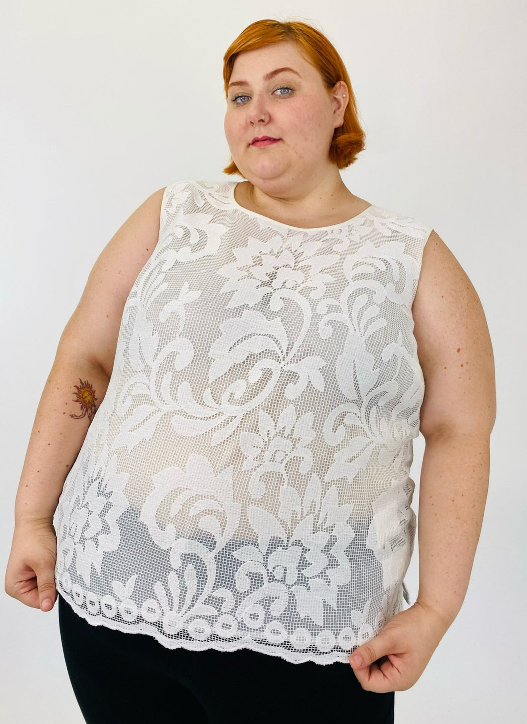 This size 24W sheer white lace tank blouse from Kasper has a scalloped hem. Model is a size 22.